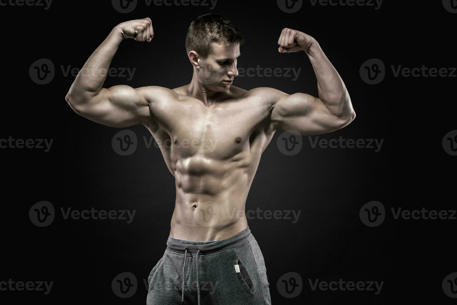 Fitness man model torso posing and showing perfect body photo