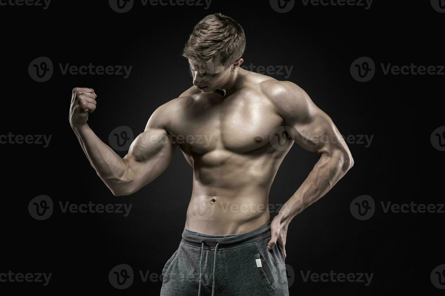 Stunning muscular man showing perfect abs, shoulders, biceps, triceps, chest photo