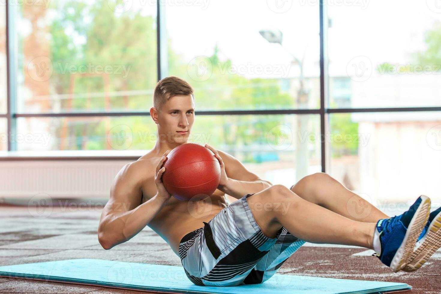 athletic muscular guy doing exercise photo