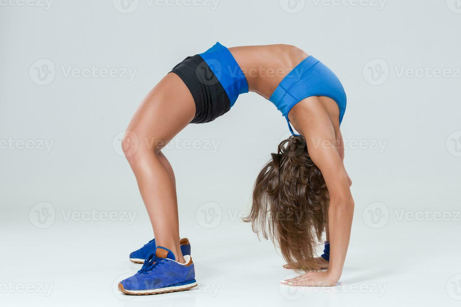 Sporty flexible girl doing stretching exercise photo