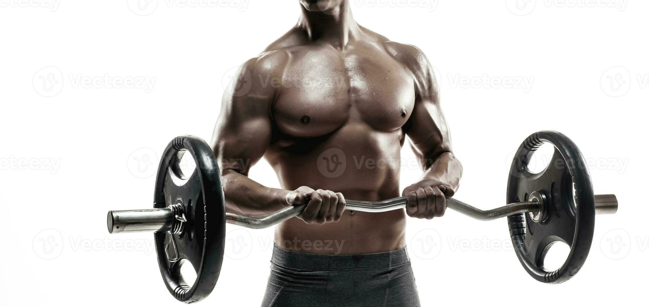 Young handsome man with naked torso and barbell photo