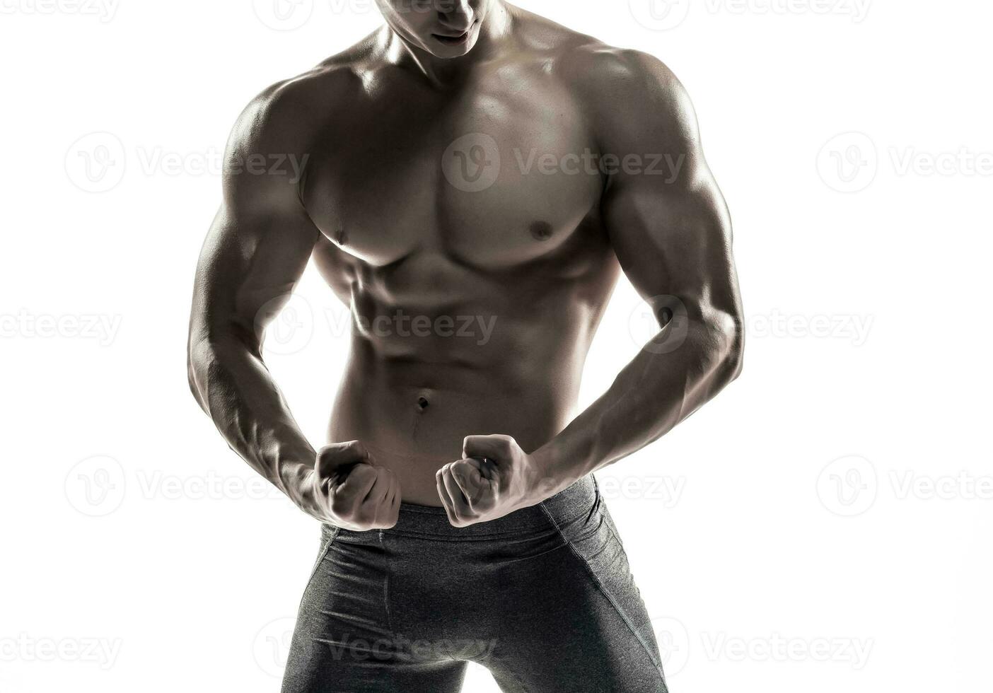 Bodybuilder man posing, showing perfect abs, houlders, biceps, triceps, chest photo