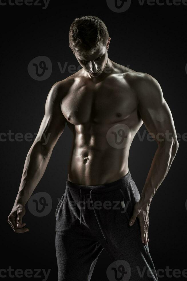 Sporty healthy man posing and showing his perfect boddy photo