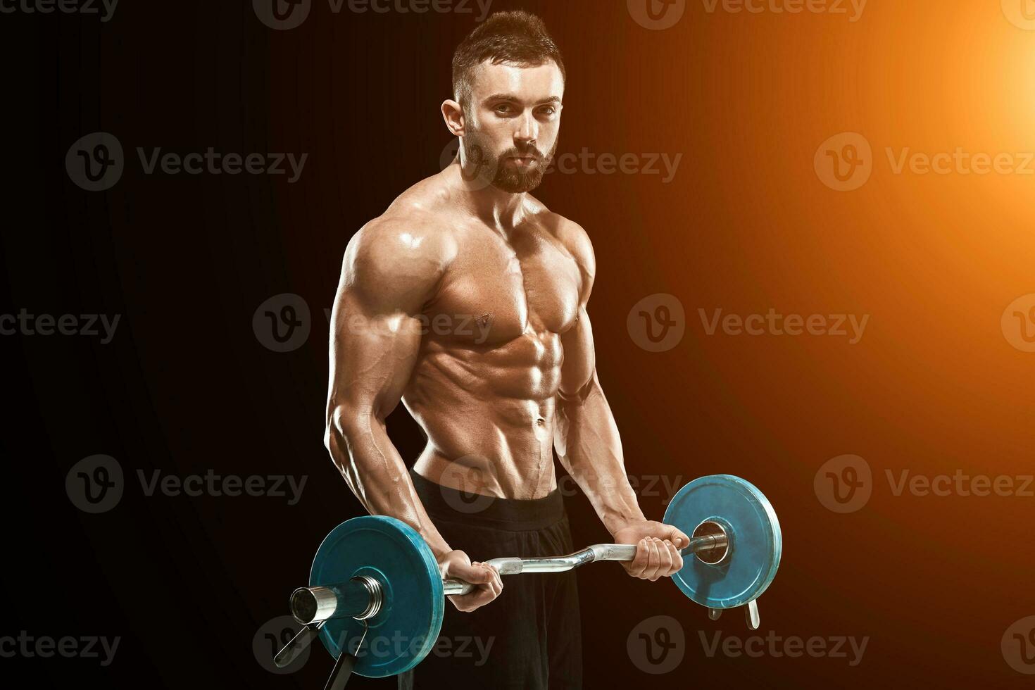 muscular man lifting weights over dark background photo