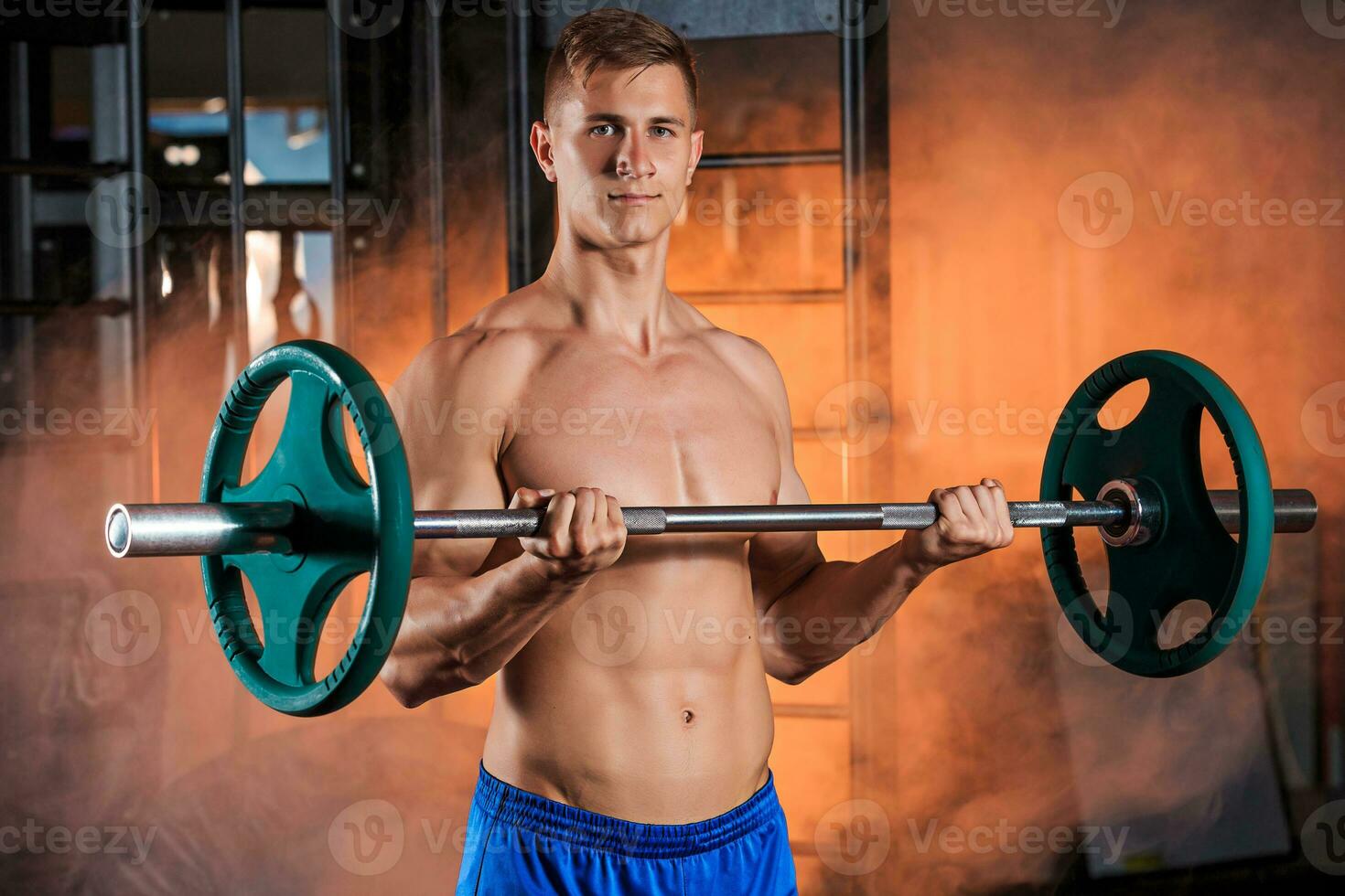 man doing exercises with barbell photo