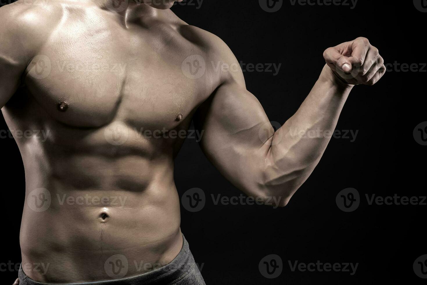 Close-up of man flexing showing his triceps, biceps muscles photo