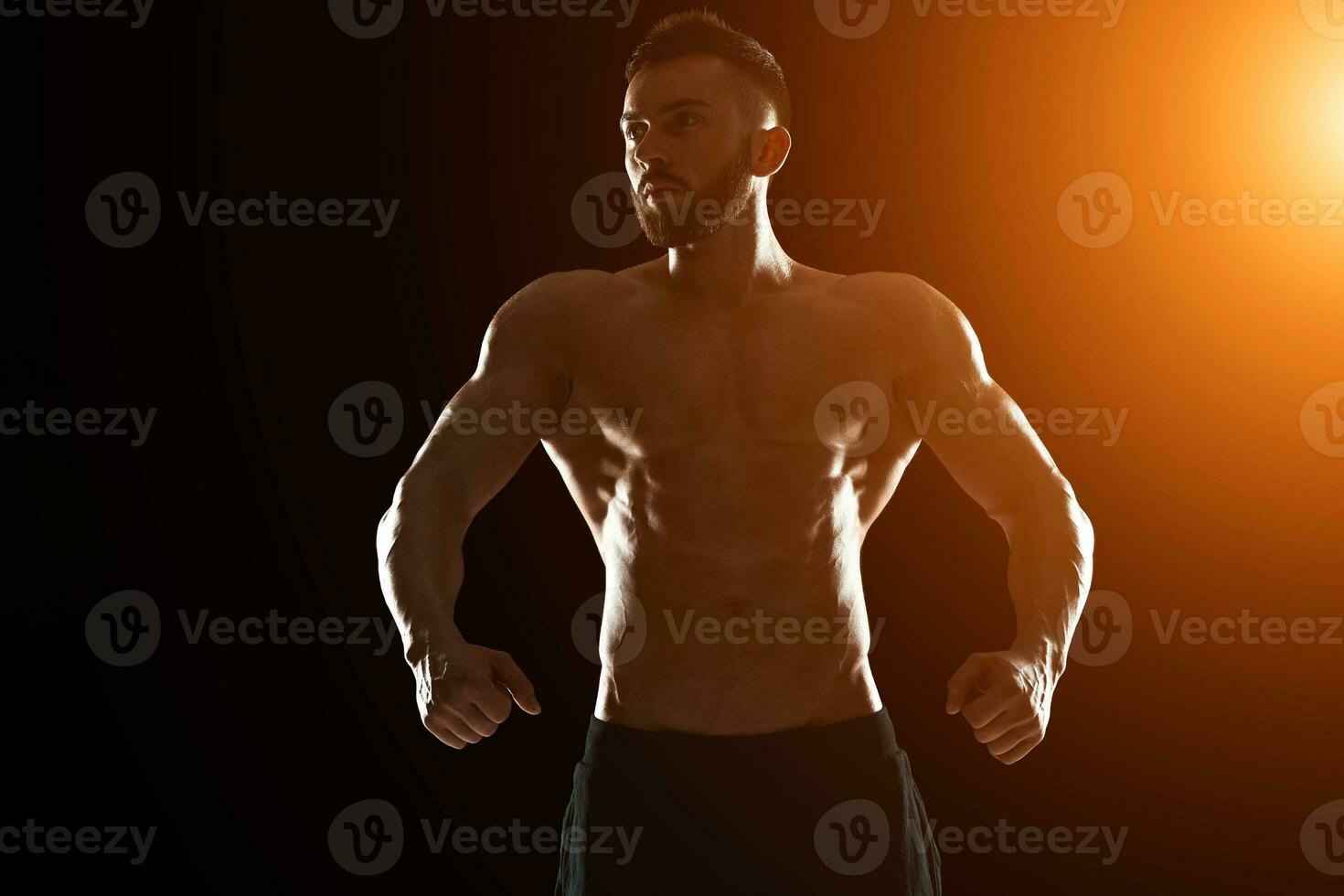 Muscular bodybuilder guy doing posing photo