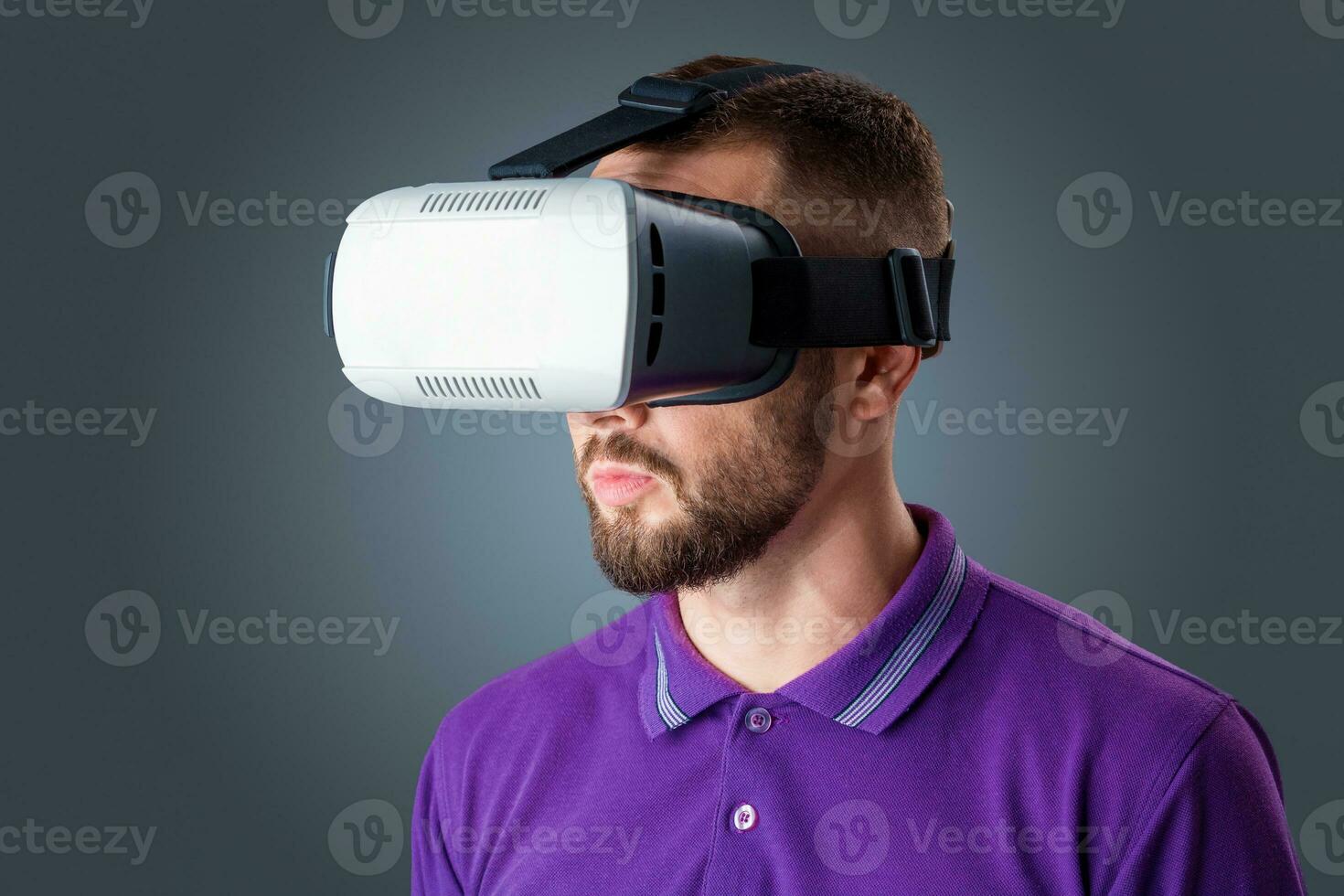 young man using a VR headset glasses photo