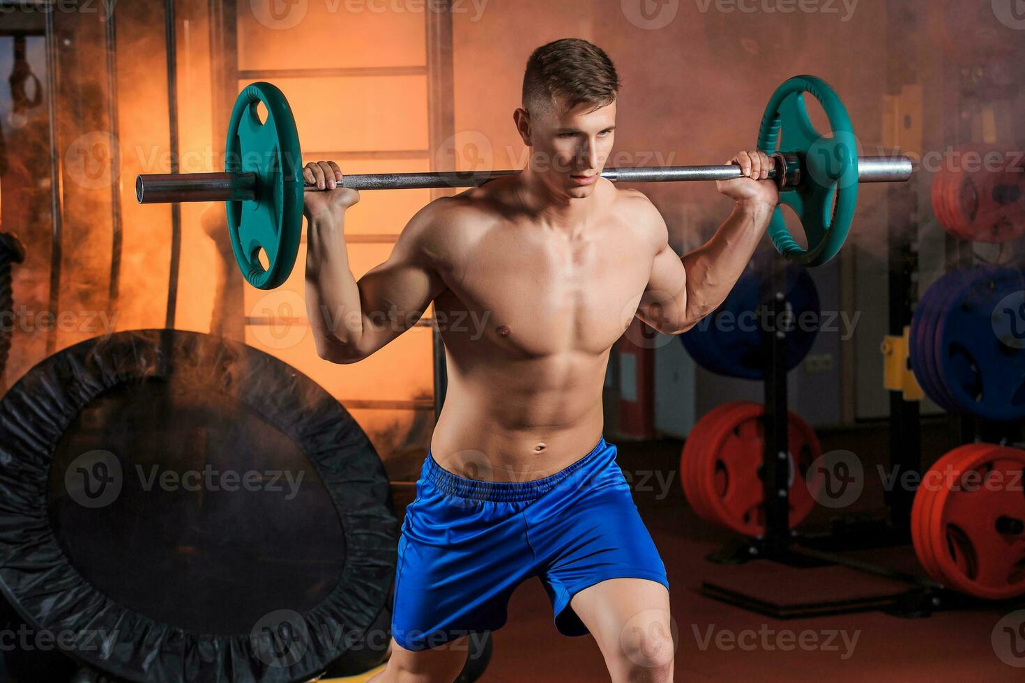 man doing exercises with barbell photo