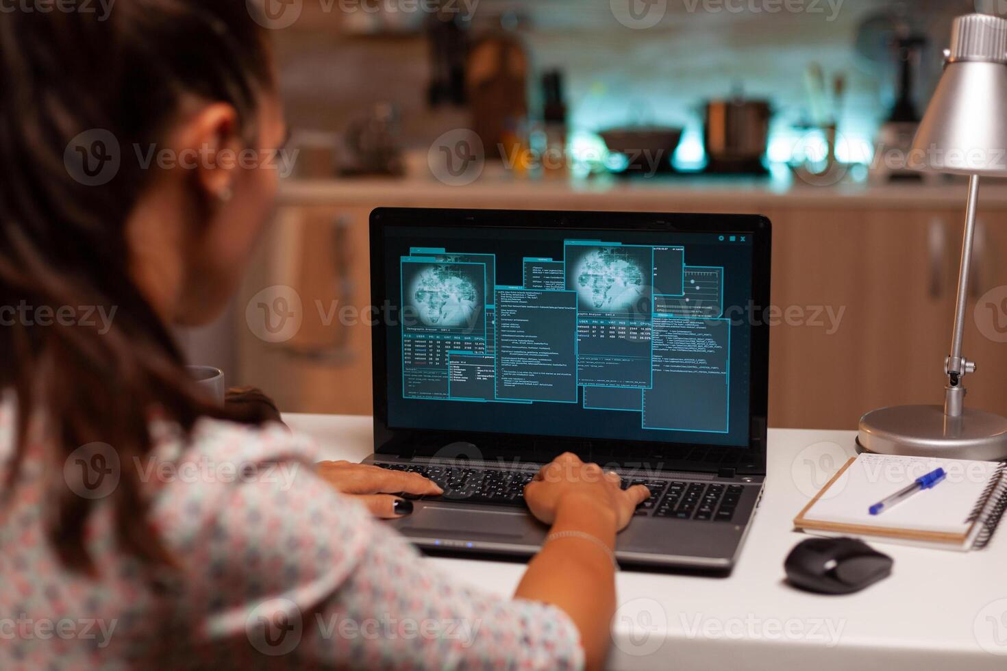 Female hacer cracking security firewall late at night from home. Programmer writing a dangerous malware for cyber attacks using performance laptop during midnight. photo