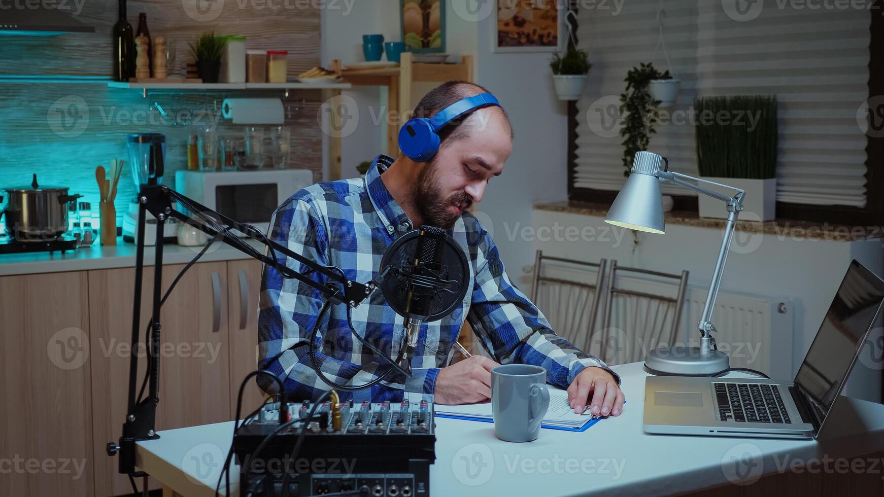 Social media analyst speaking on microphone during podcast in home studio with neon light in the background. Creative online show Onair production internet broadcast host streaming live content, recording digital social media communication photo