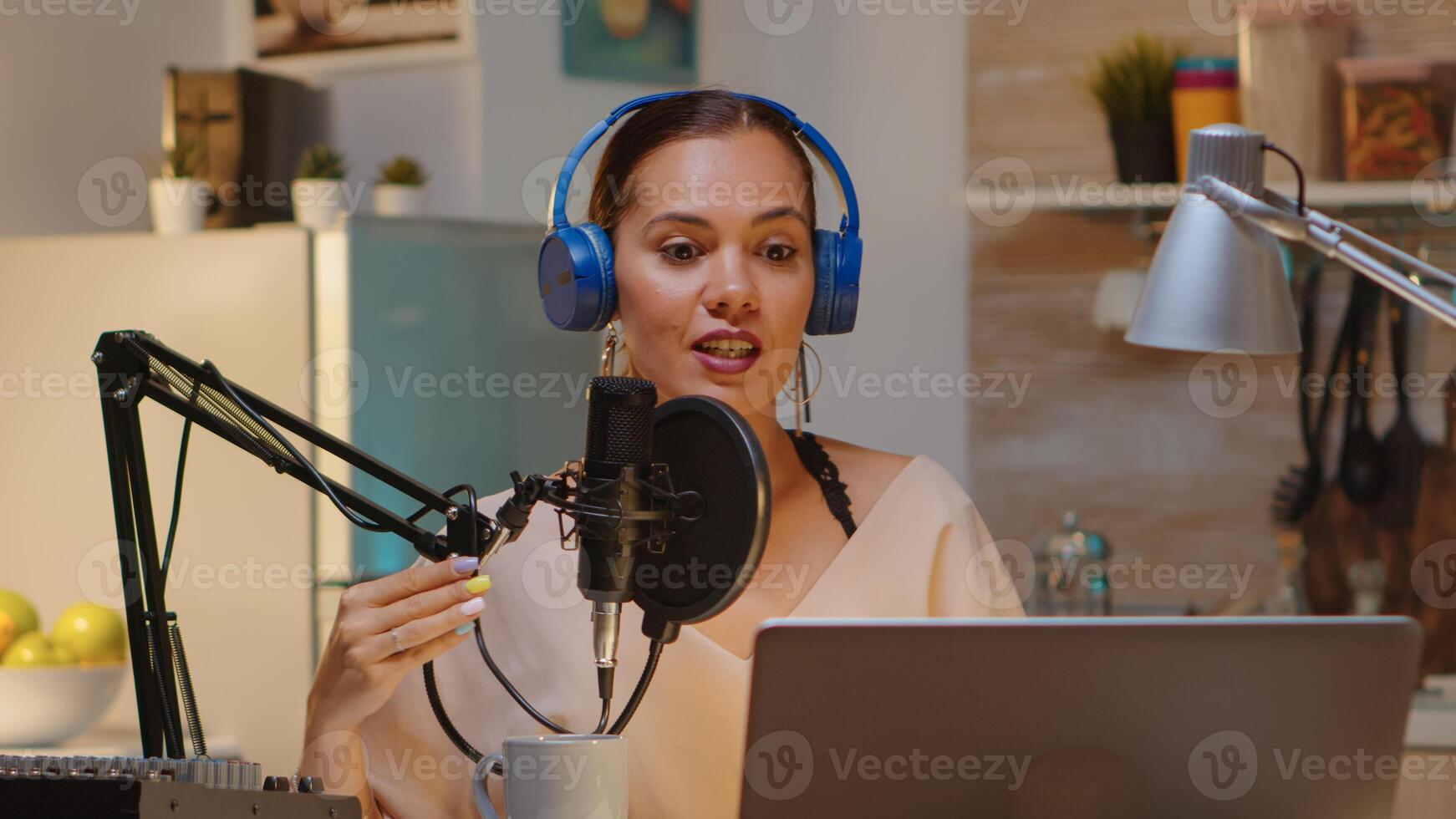 Creative influencer with headphones speaking with fans during live on social media using professional gear. Onair online production internet broadcast show host streaming live content photo