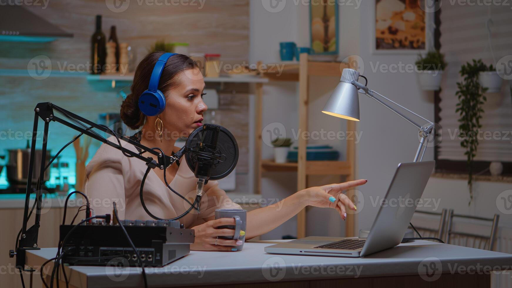 Vlogger speaking with follower on live using professional microphone wearing headphones. Creative online show Onair production internet broadcast host streaming live content, recording digital social media communication photo