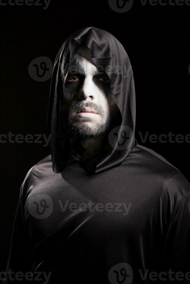Creepy man dressed up like grim reaper for halloween. photo