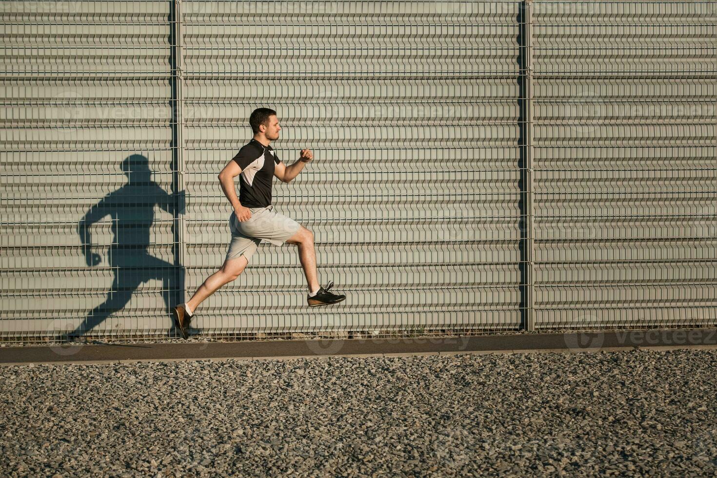 Full length portrait of athletic man running photo