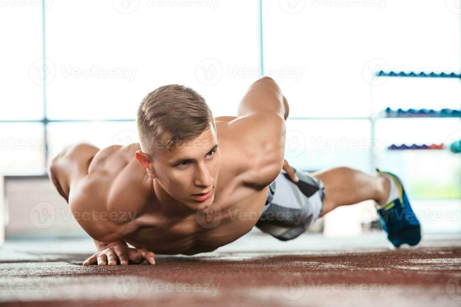 athletic muscular guy doing push-ups photo