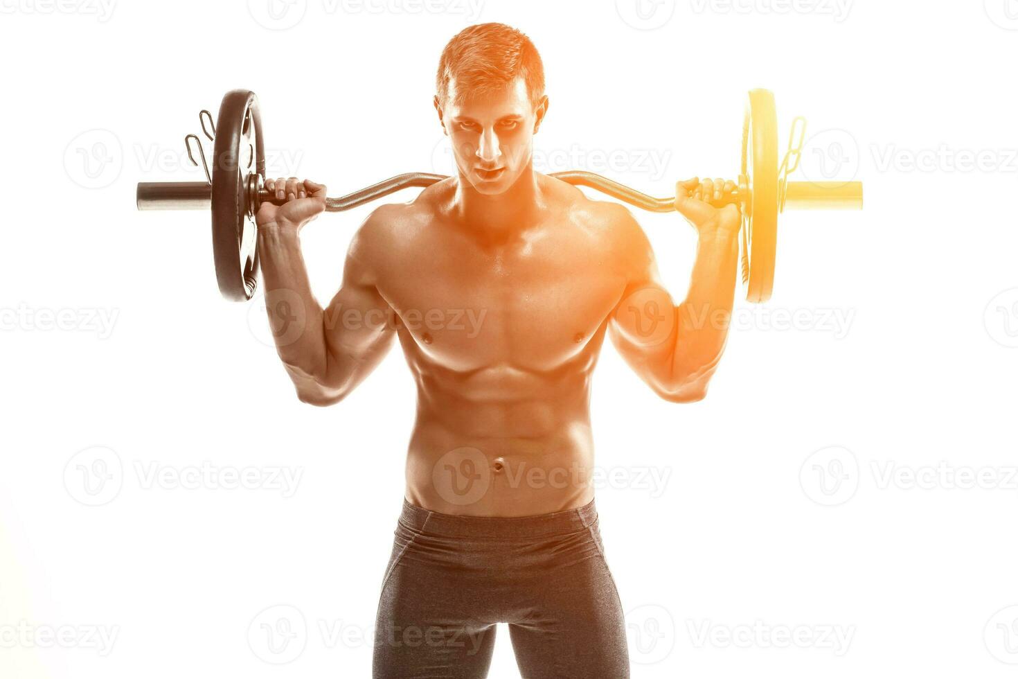 Strong man exercising fitness body building exercises with a barbell photo
