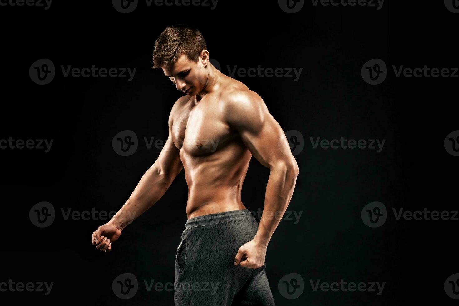 Image of very muscular man posing with naked torso photo
