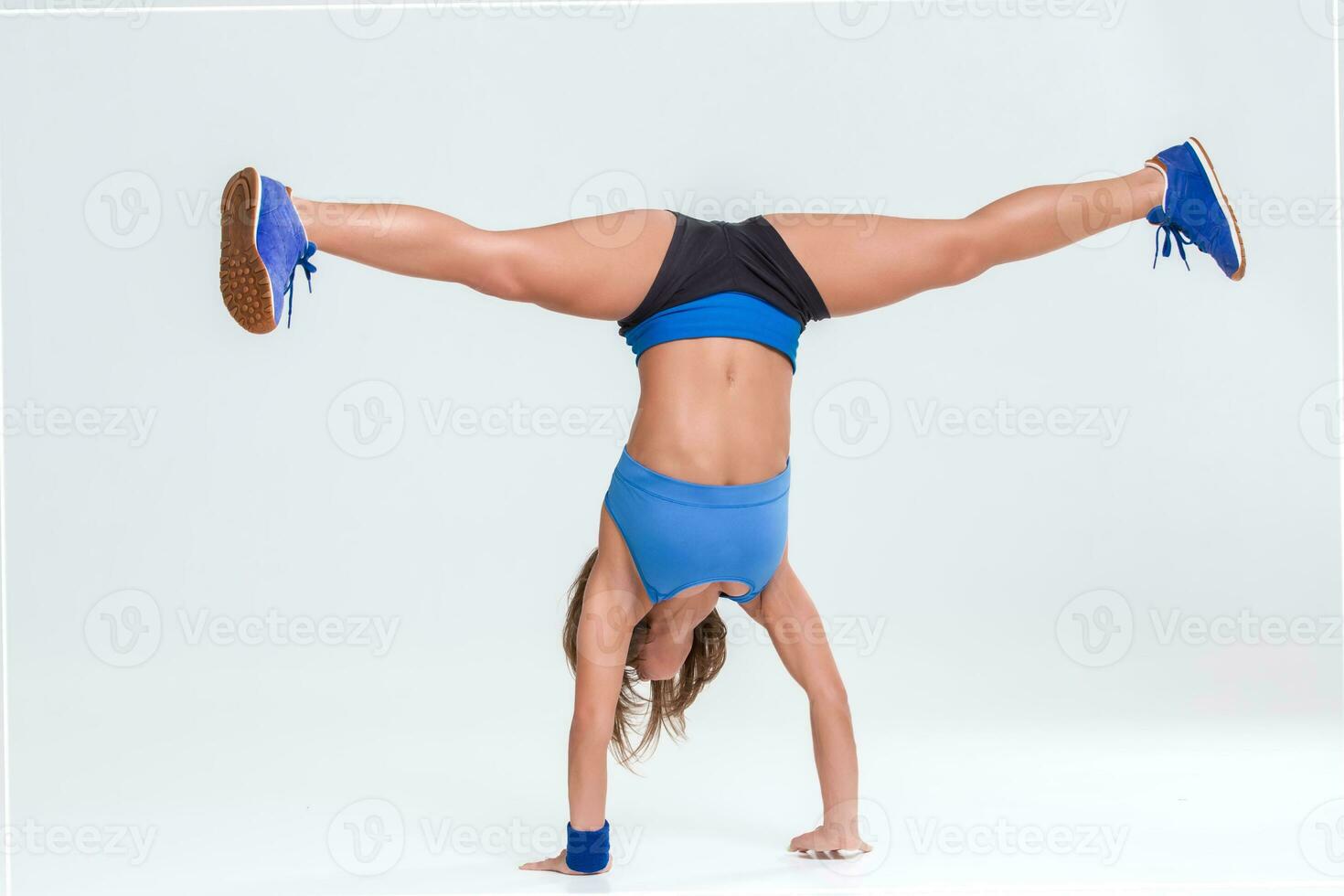 Sporty flexible girl doing stretching exercise photo