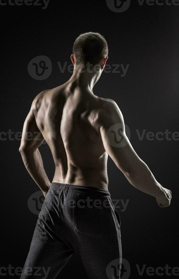 Stunning muscular man fitness model torso showing muscles back photo