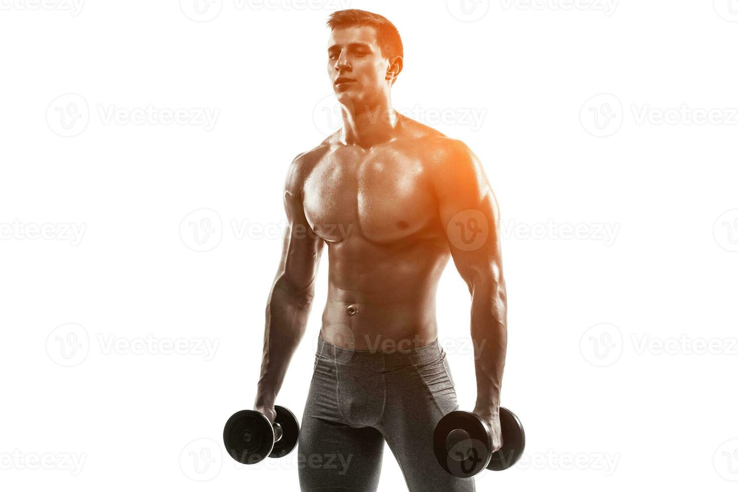 Muscular man showing perfect body with dumbbells, isolated on white photo