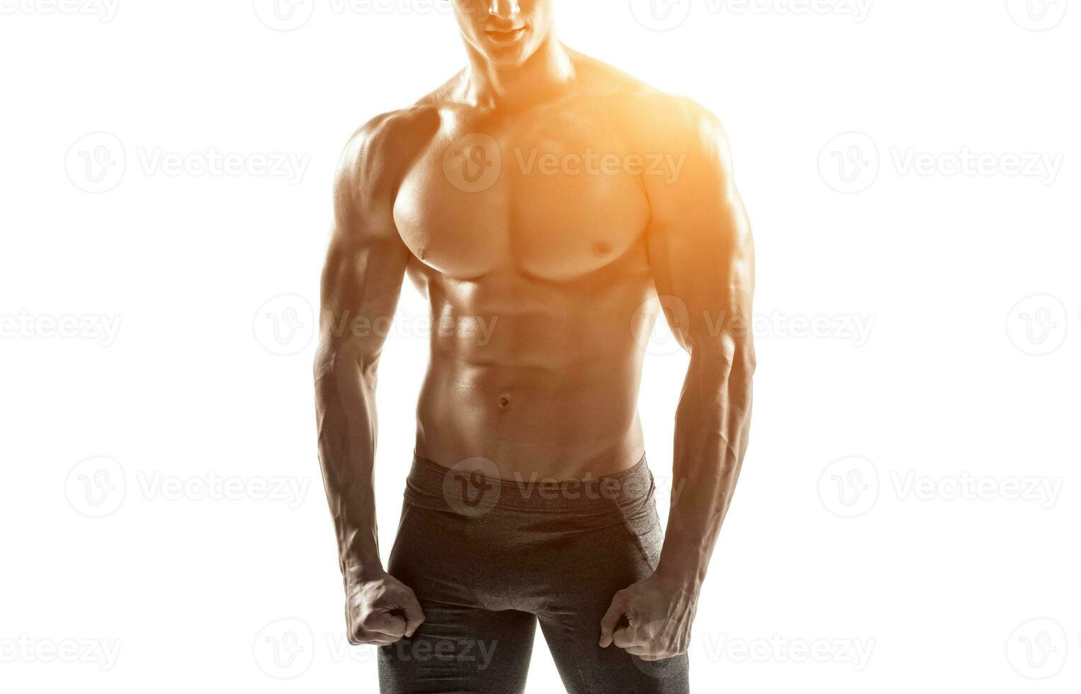 Strong man showing perfect abs, houlders, biceps, triceps and chest photo