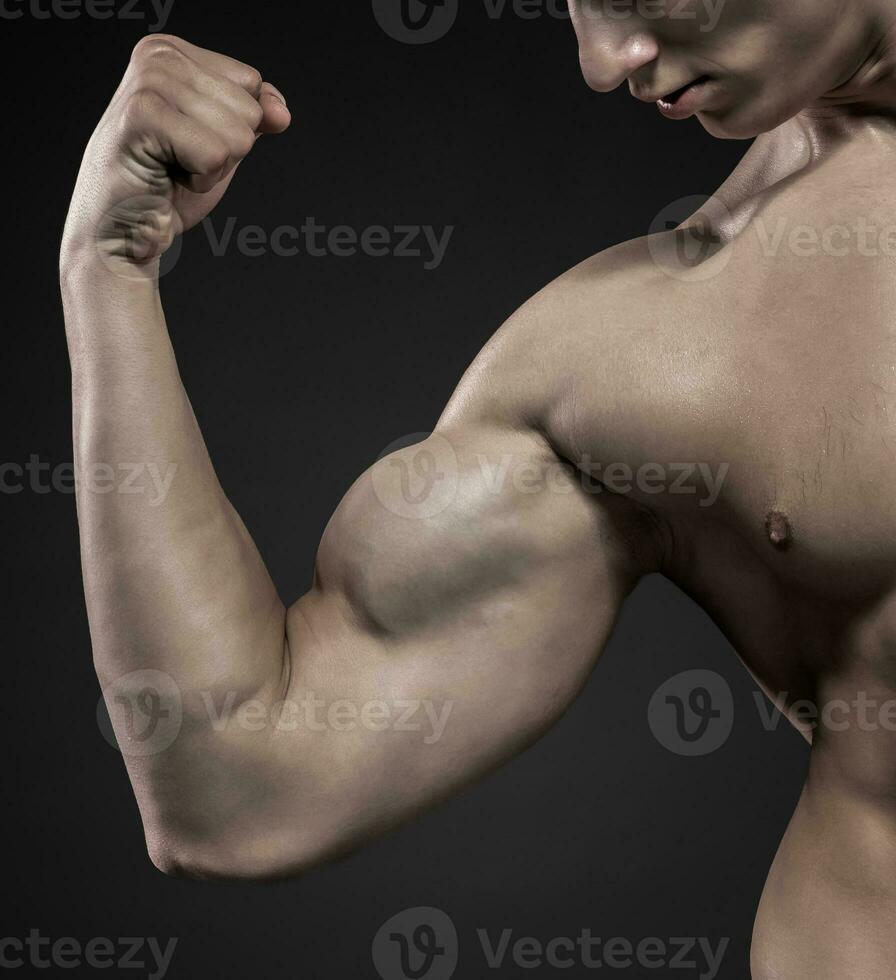 Image of very muscular man posing with naked torso photo