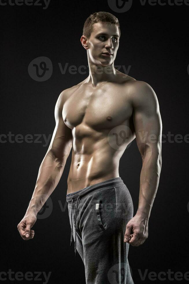 Image of very muscular man posing with naked torso photo