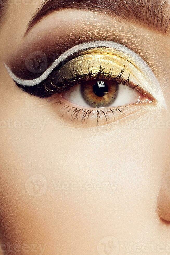 Magic Girl Portrait in Gold. Golden Makeup photo