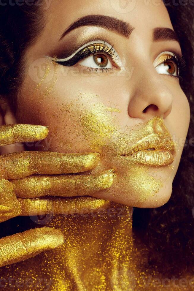 Magic Girl Portrait in Gold. Golden Makeup photo