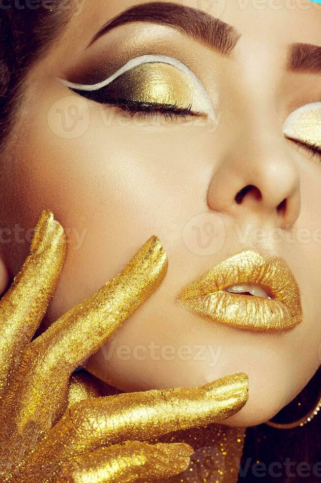 Magic Girl Portrait in Gold. Golden Makeup photo