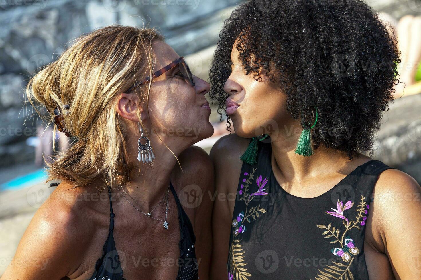 couple of beautiful women kissing photo