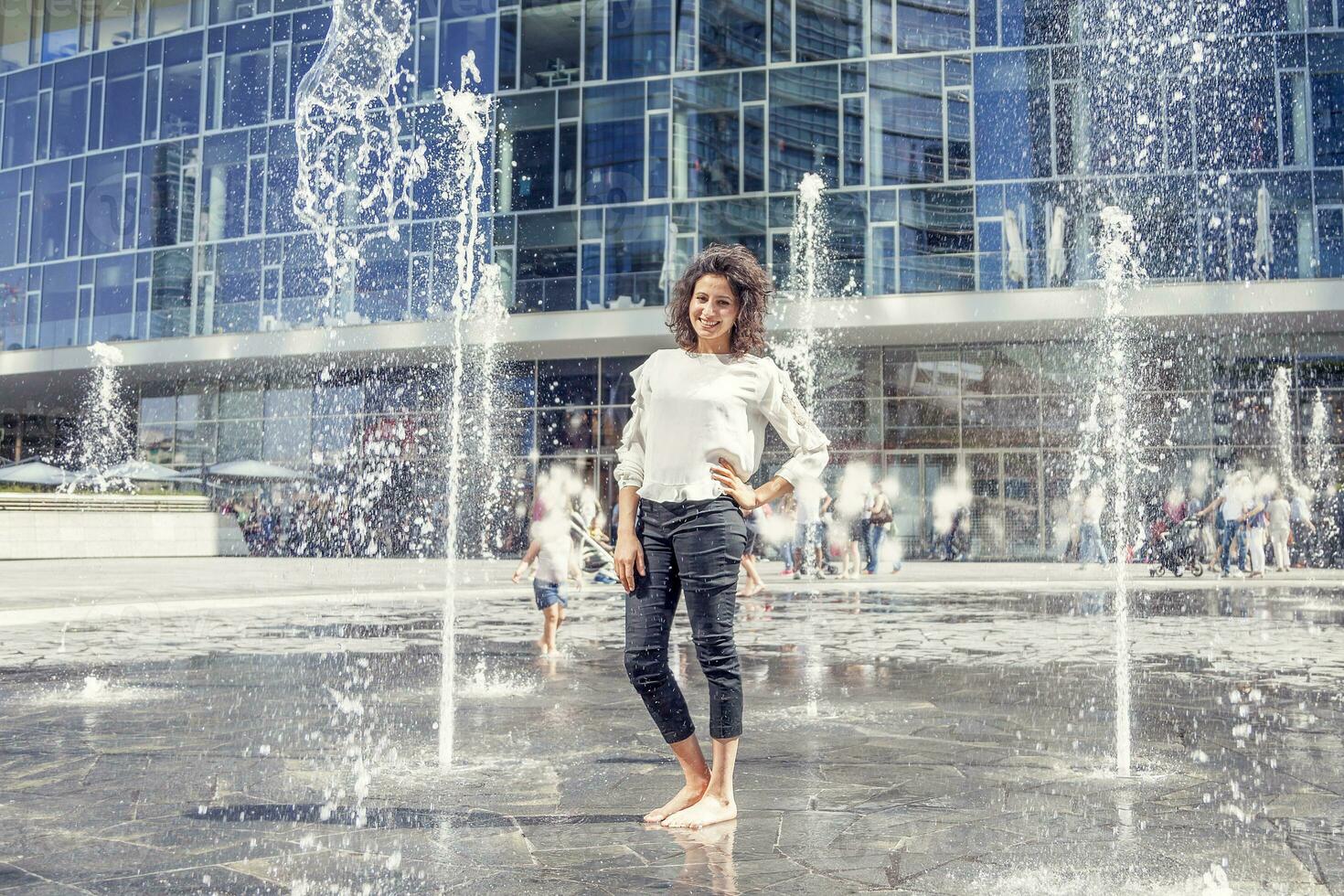 pretty girl plays with splashes of water photo