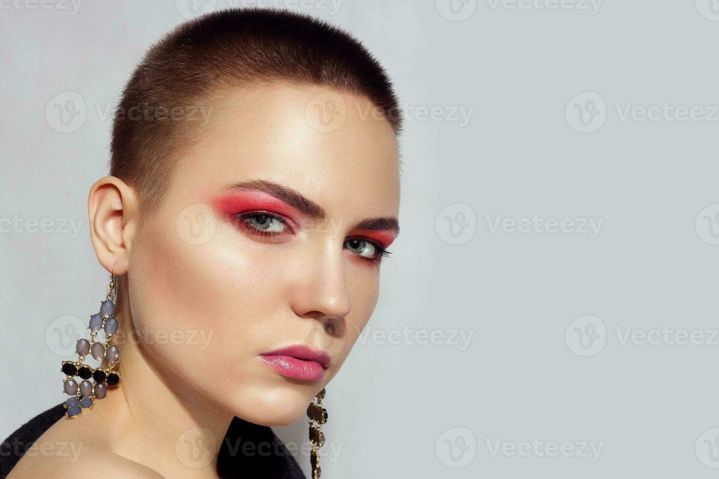 Beautiful fashion model Woman brunette short hair and red eyelids photo