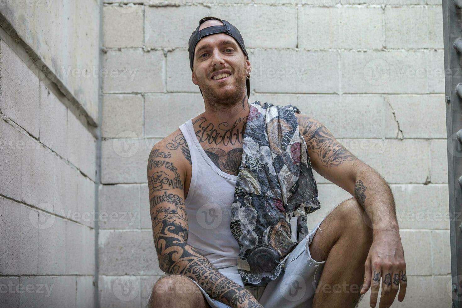 young caucasian tattooed singer rap posing photo