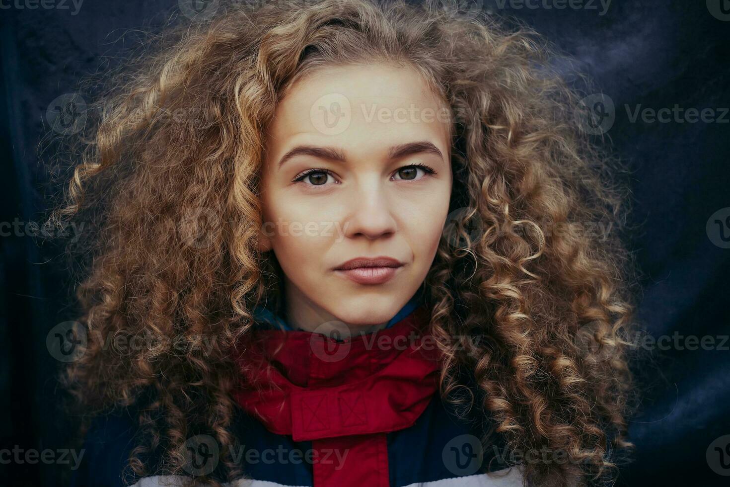 Close-up portrait beautiful model curly blond hair black background photo