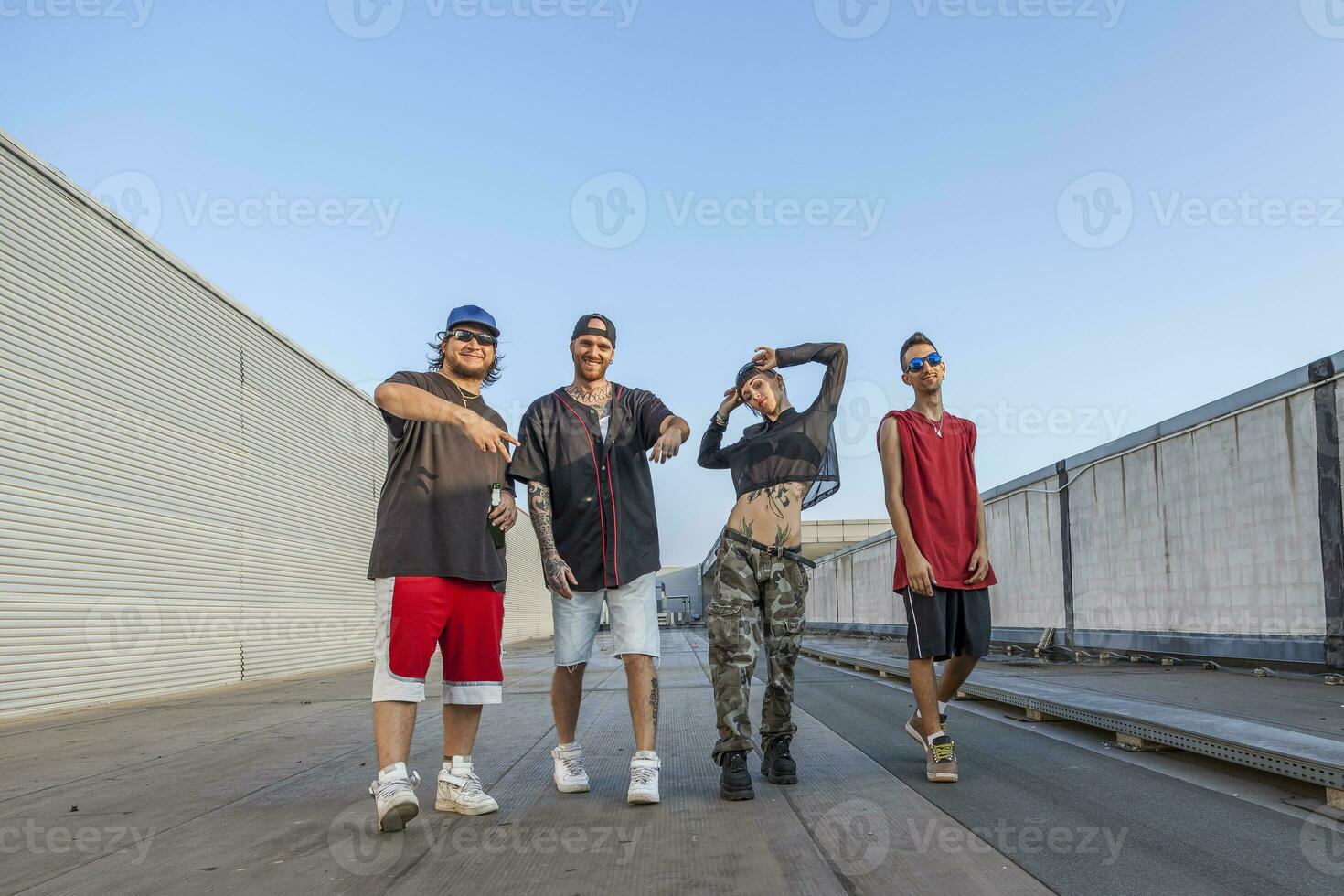 group of rappers posing on the metal rooftops photo