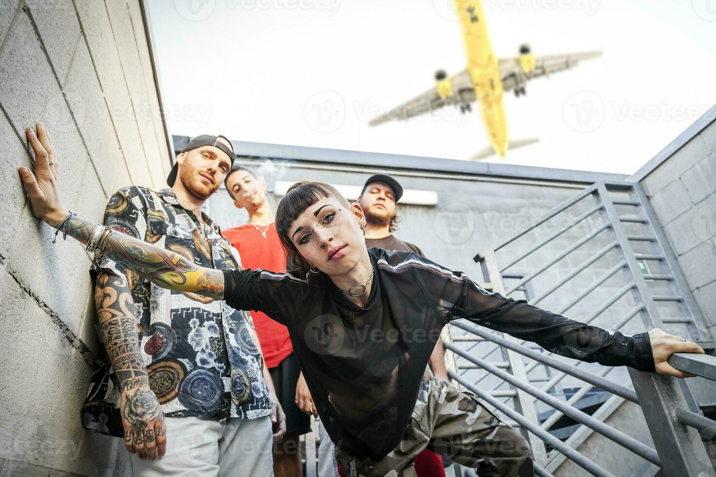 group of rappers posing on the metal stairs photo