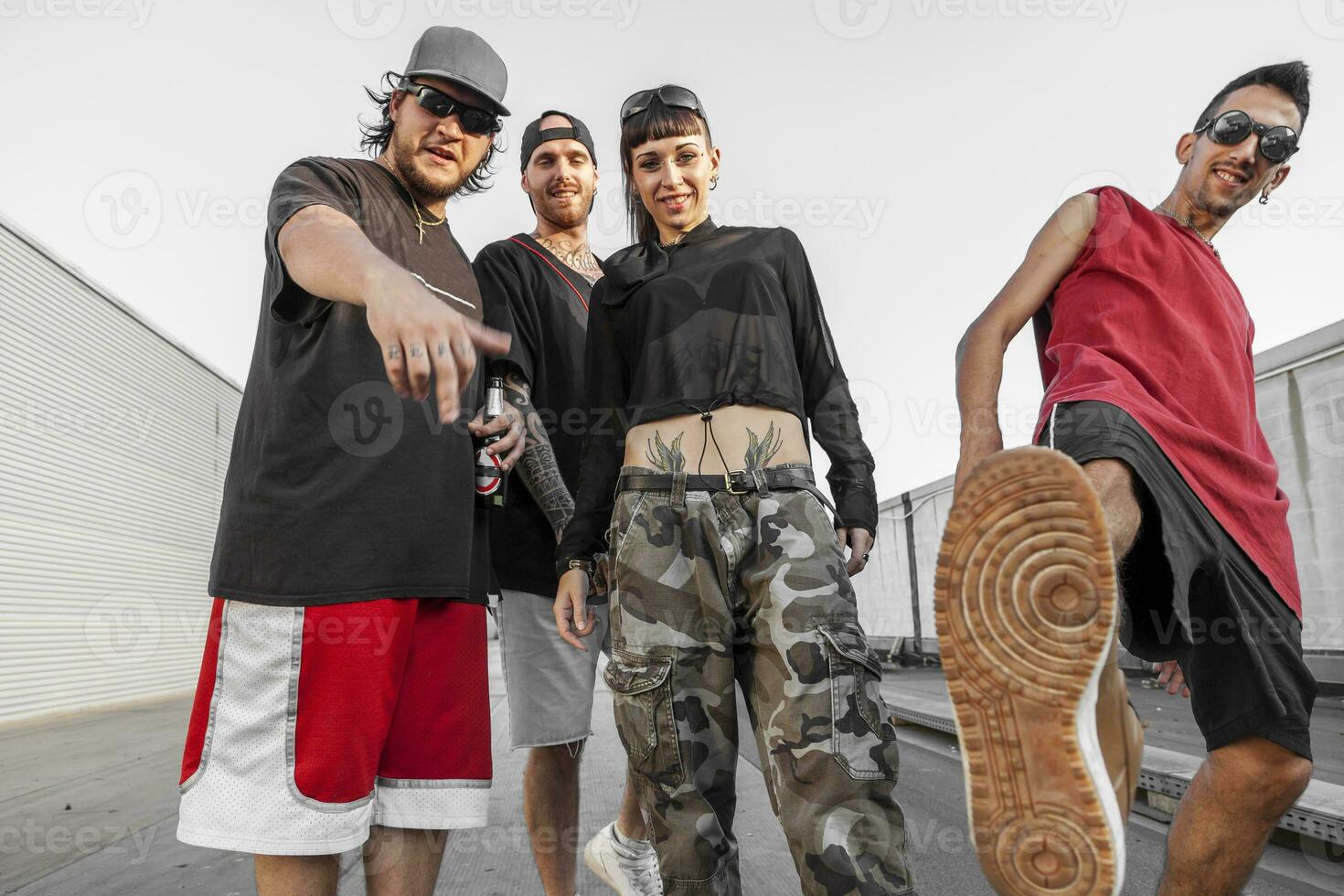 group of rappers posing on the metal rooftops photo