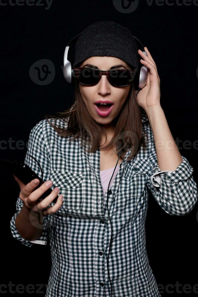 happy listening music with big headphones  phone or player photo