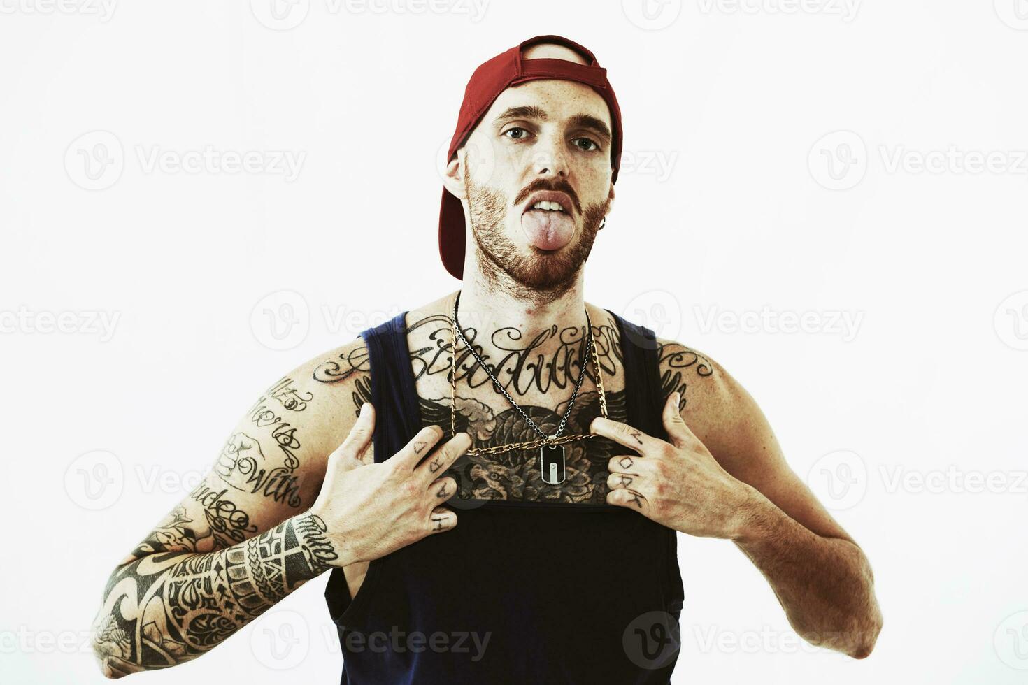 tattooed rap singer posing in studio on a white background photo