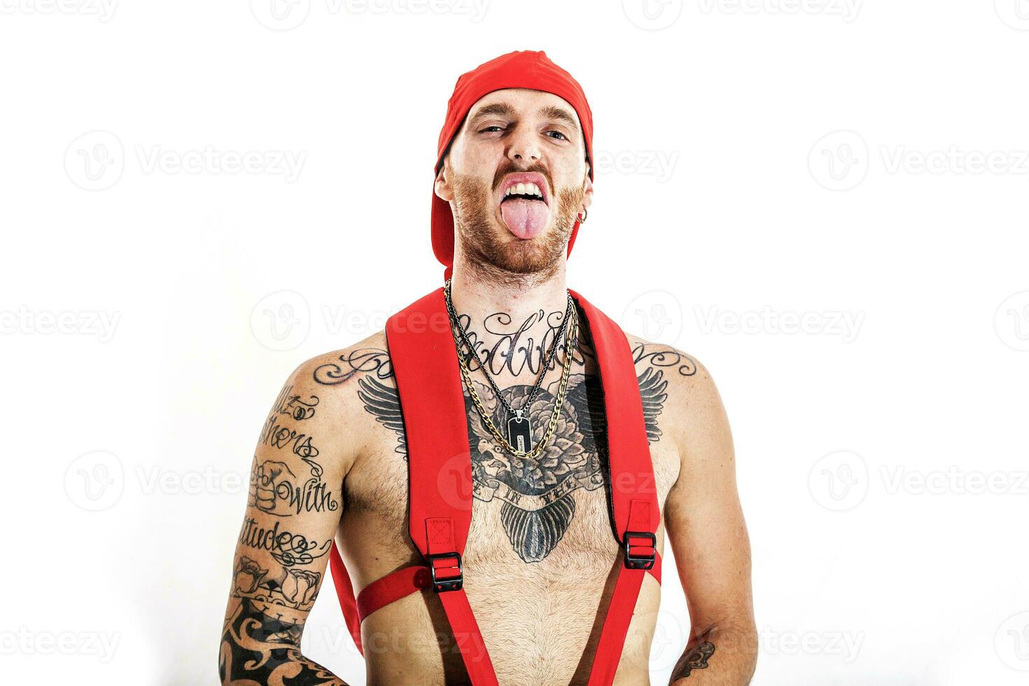 tattooed rap singer posing in studio on a white background photo