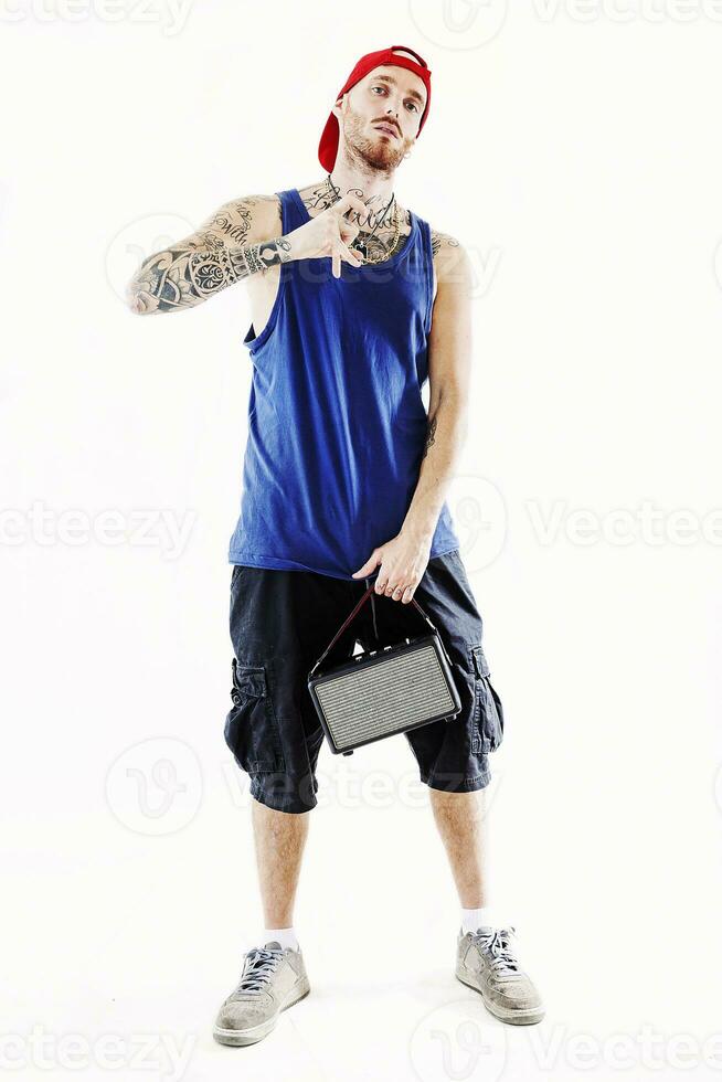tattooed rap singer posing in studio with an amplified radio photo