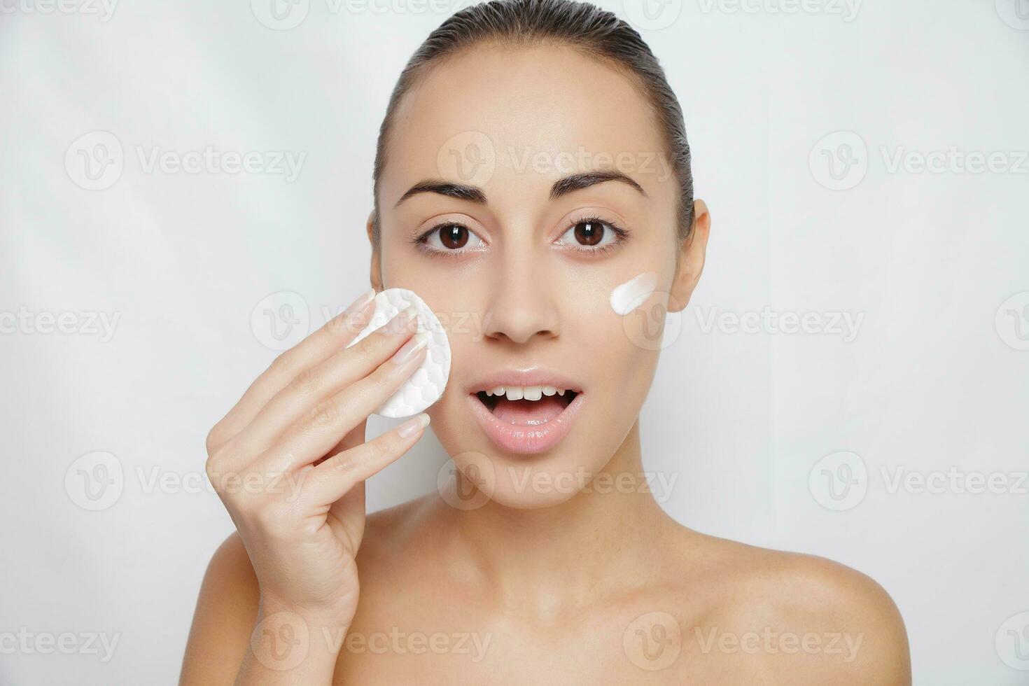 young woman cares for face skin photo