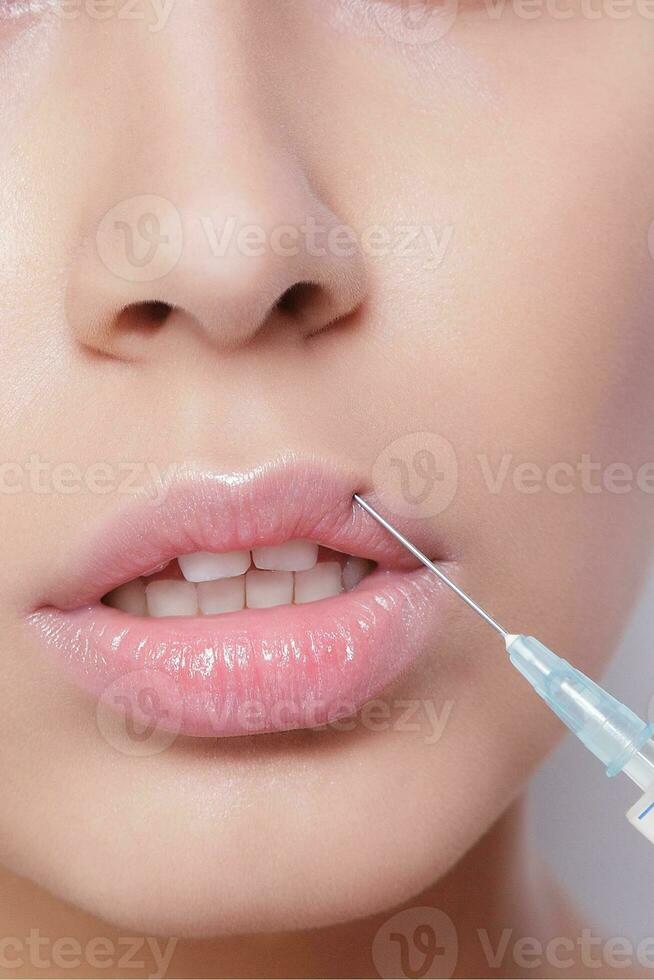 Attractive young woman gets cosmetic injection photo