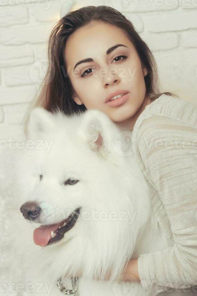 Young beautiful woman with husky dogs Christmas setting photo