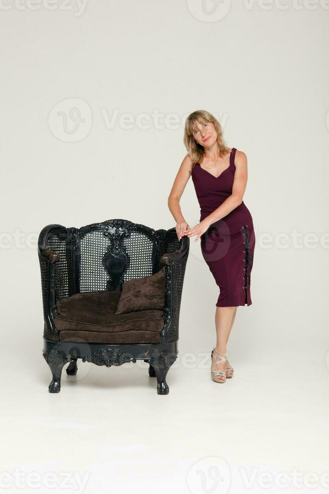 Portrait of a stunning fashionable model sitting in a chair photo