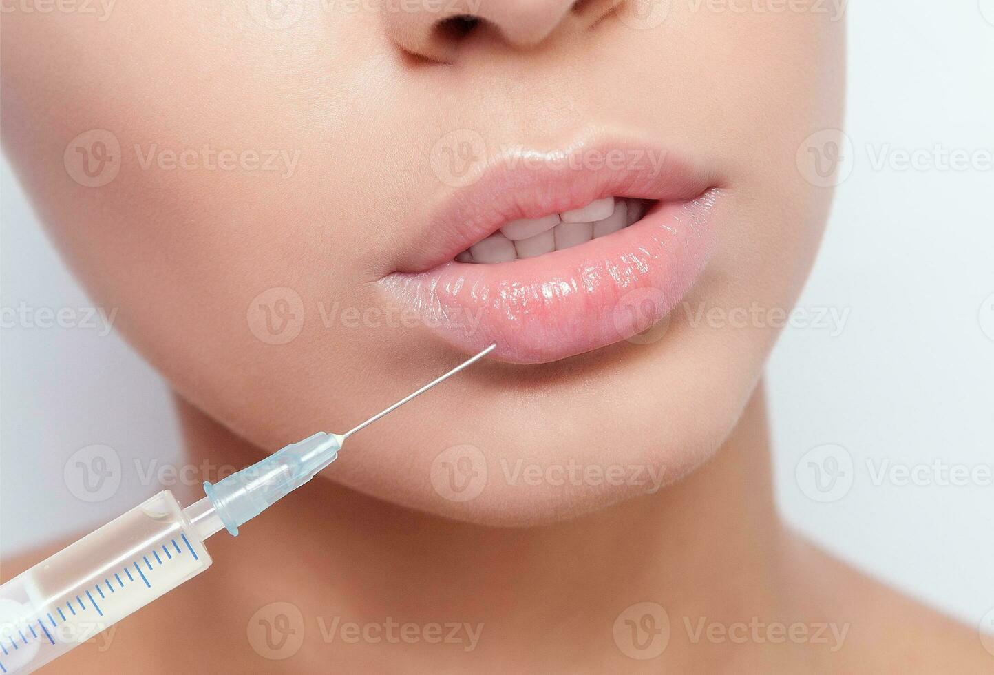 Attractive young woman gets cosmetic injection photo