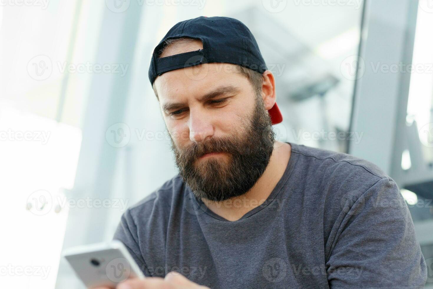 Smiling handsome man writing message on the phone photo