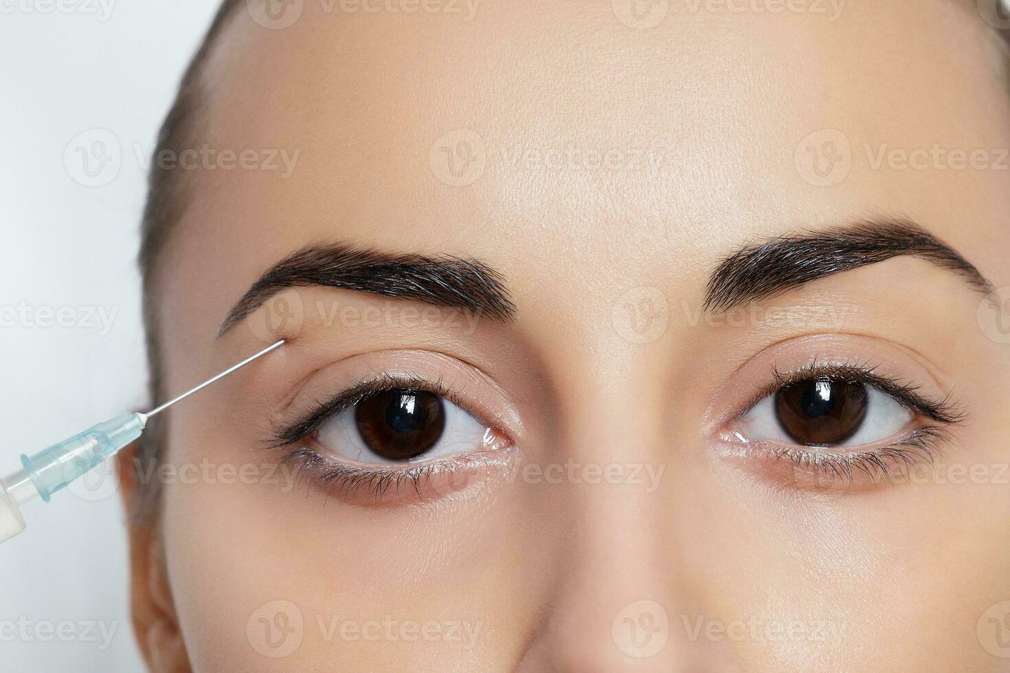 Attractive young woman gets cosmetic injection photo